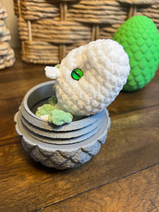 Gray dragon egg with white baby dragon